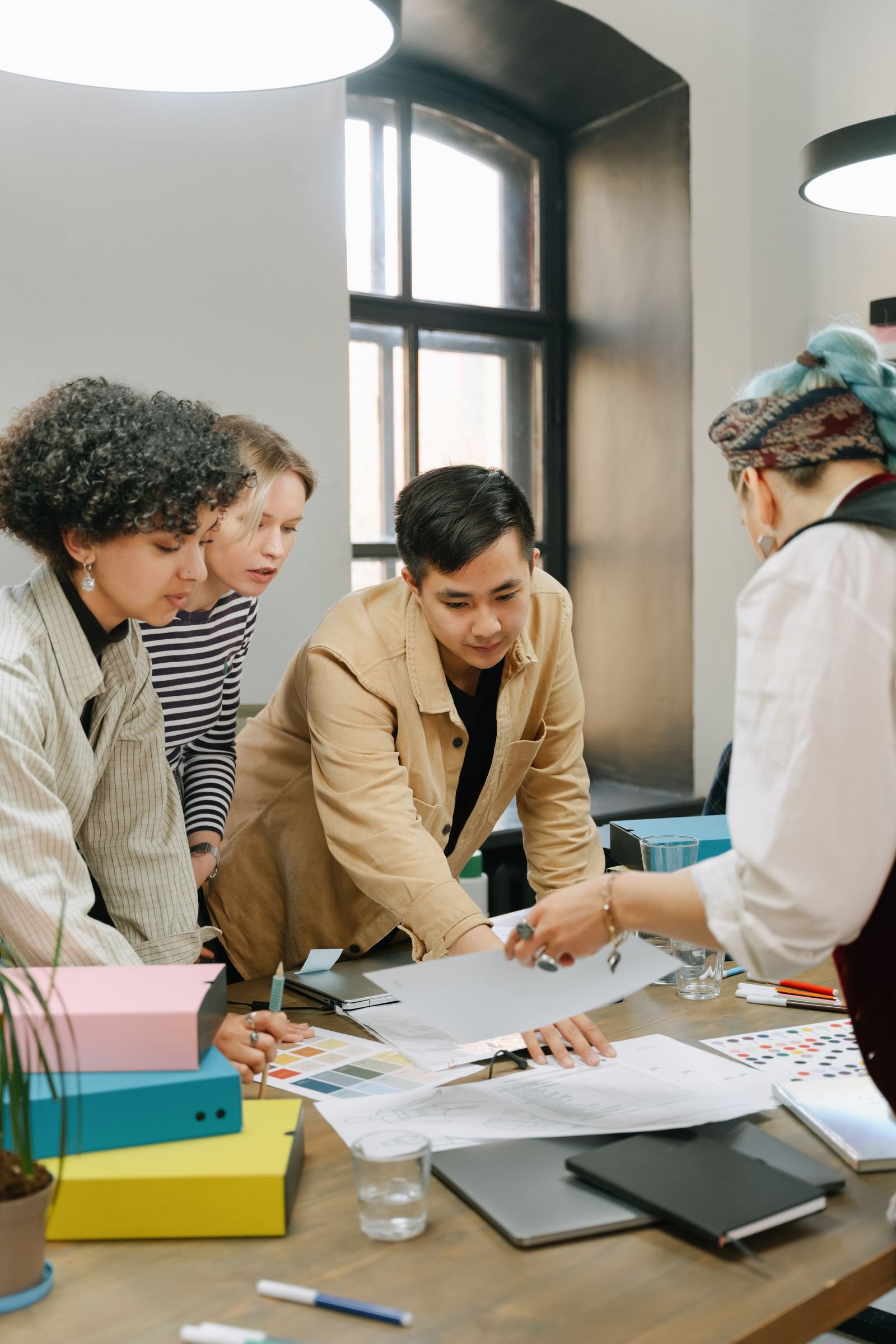 Design team sketching around a table