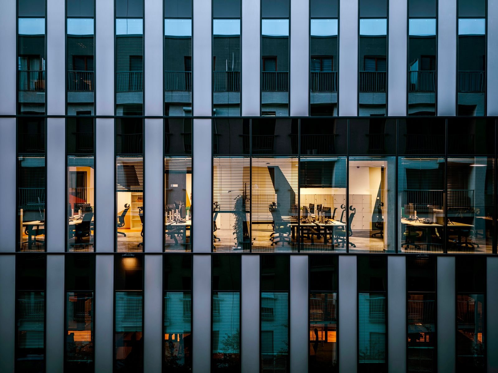 Glass office facade at dusk
